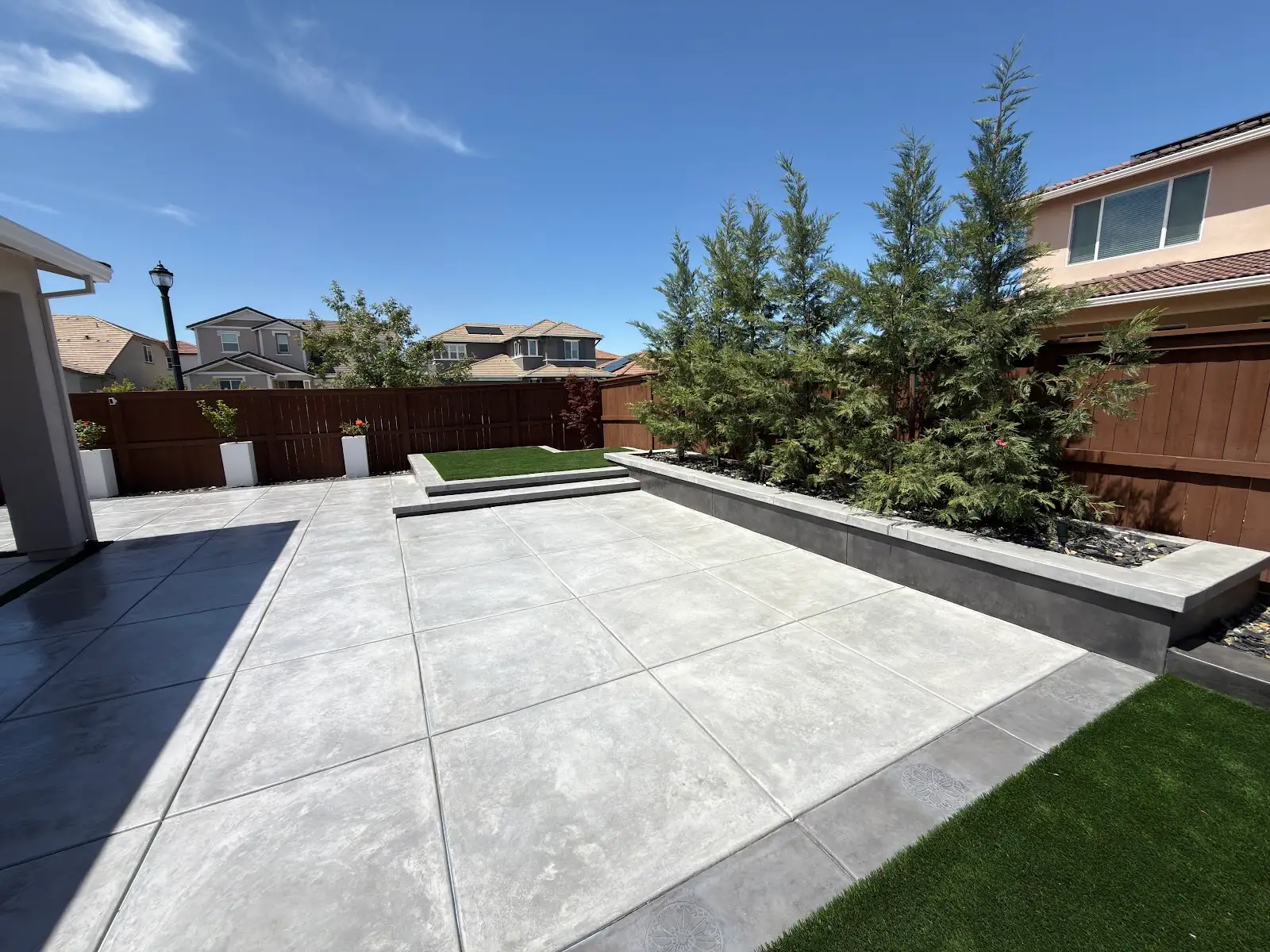 Modern concrete patio with large-format pavers and turf accent, Solano County