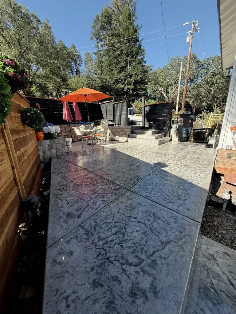 Stamped concrete patio in a narrow side yard