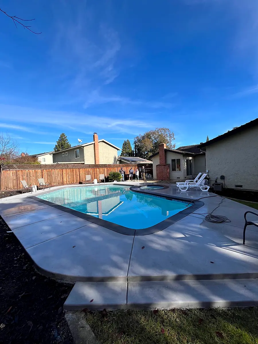 Wide concrete pool deck surround with lounge space