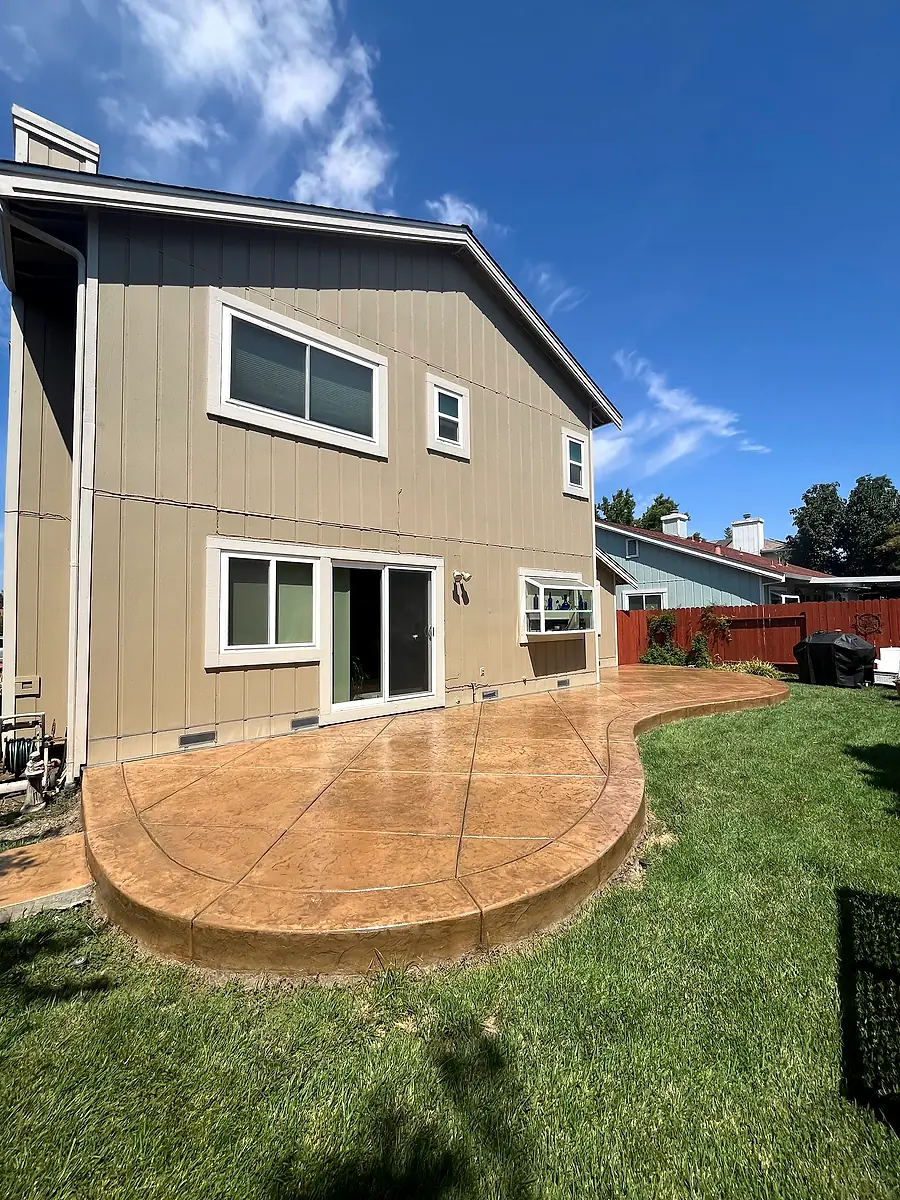 Curved stamped concrete patio with a contrasting border band
