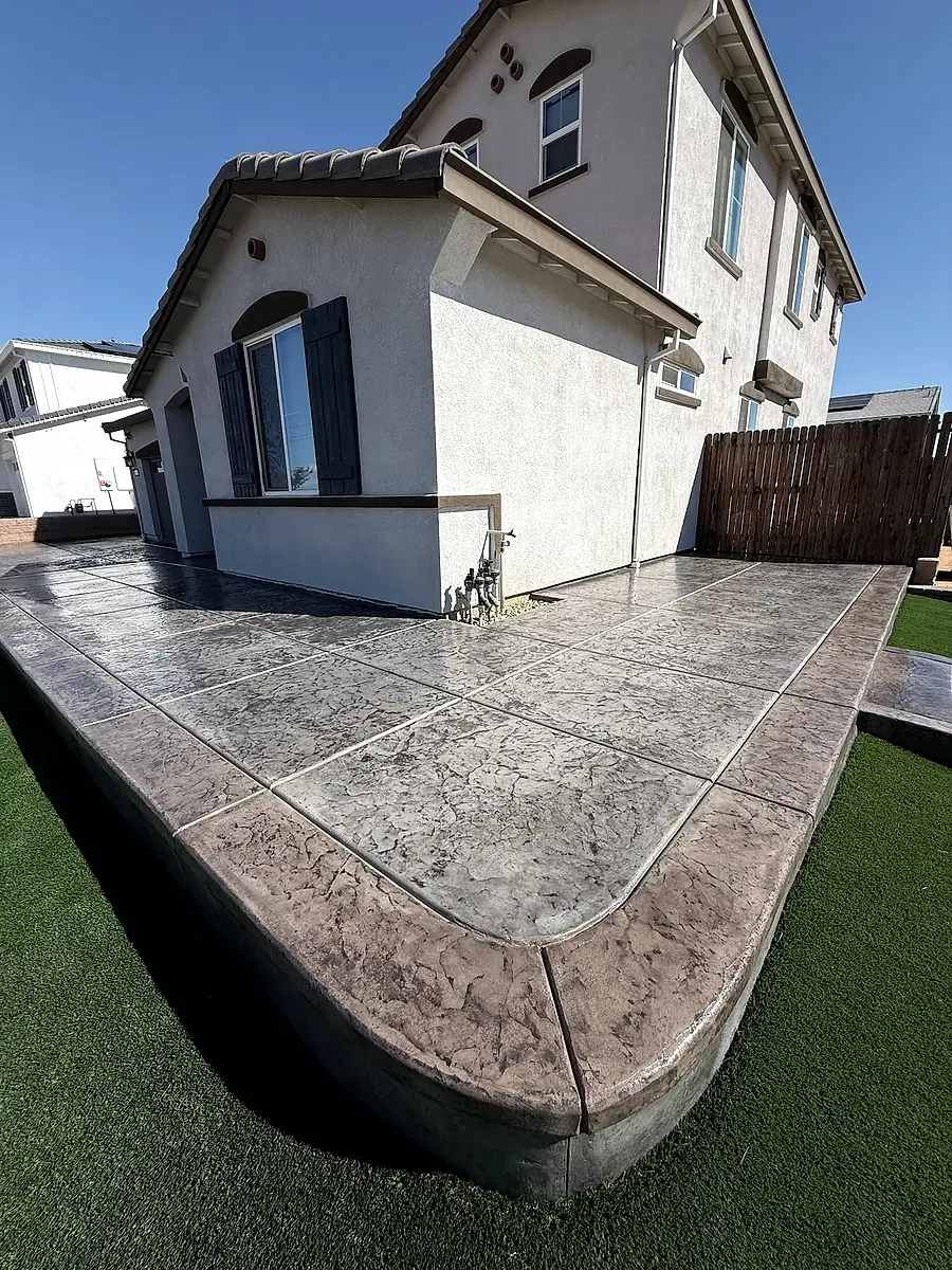 Gray stamped concrete patio with a charcoal border