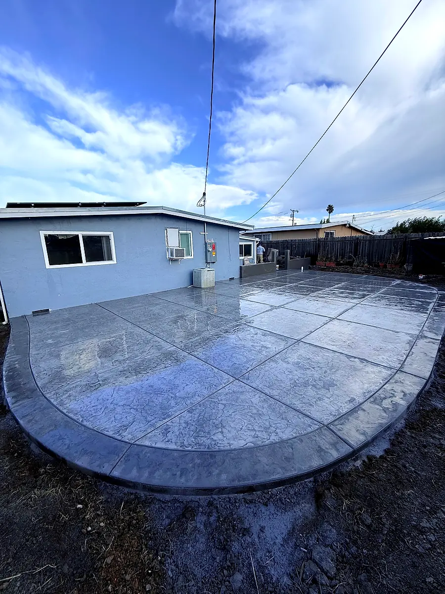 Rounded stamped concrete backyard patio