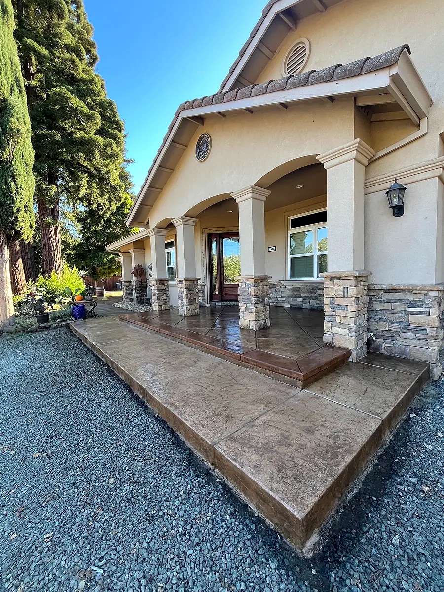 Stamped concrete front porch with stone-veneer columns
