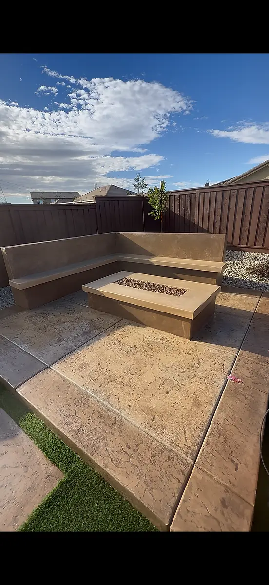 Stamped concrete patio with a seating wall and fire pit