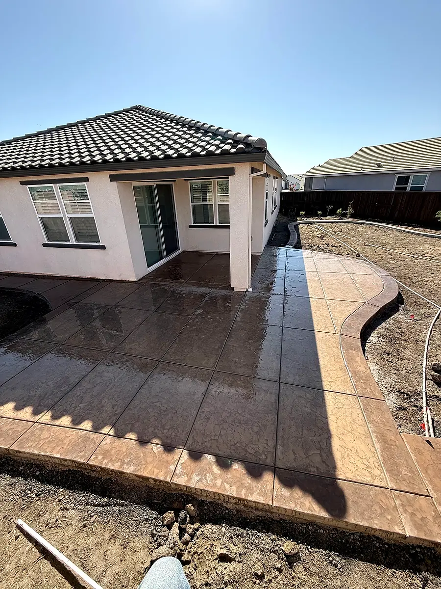 Stamped concrete wraparound patio with a dark accent border